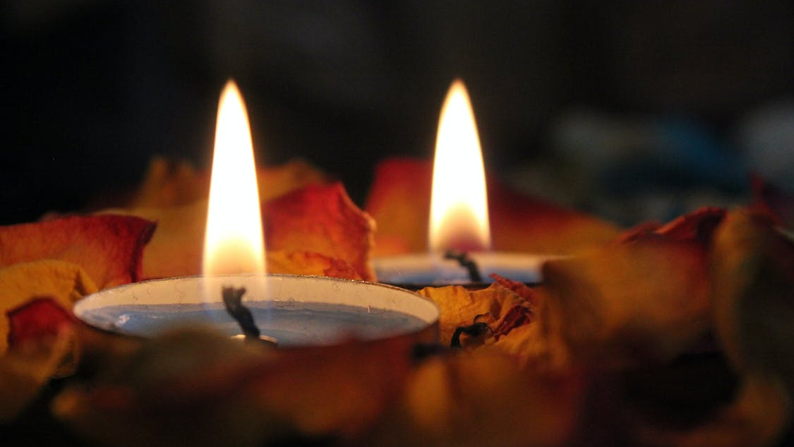 two tea lights in rose petals, romantic atmosphere, relaxation techniques 