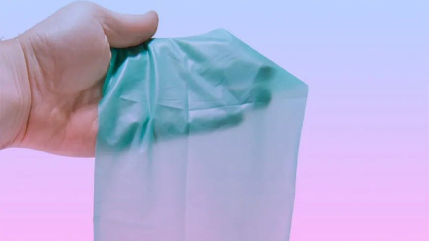 hand holding a dental dam, safe sex, oral safe sex