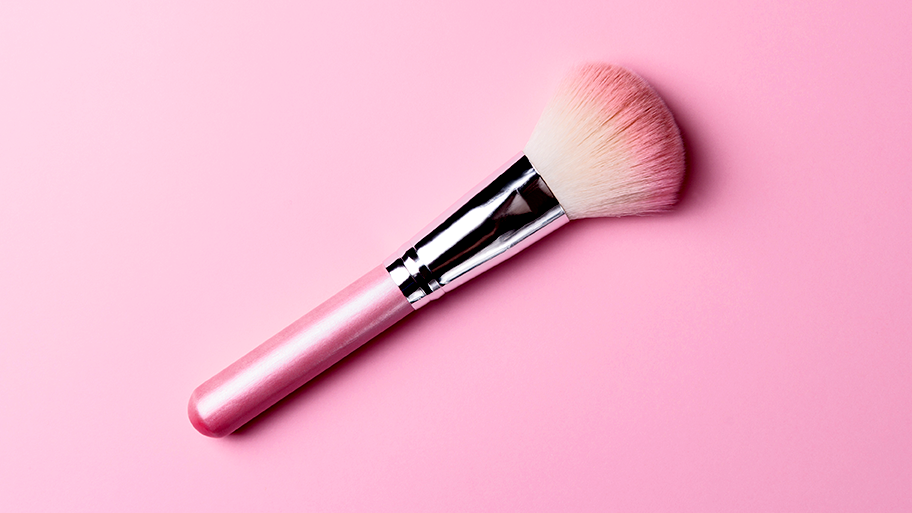 pink makeup brush on pink background